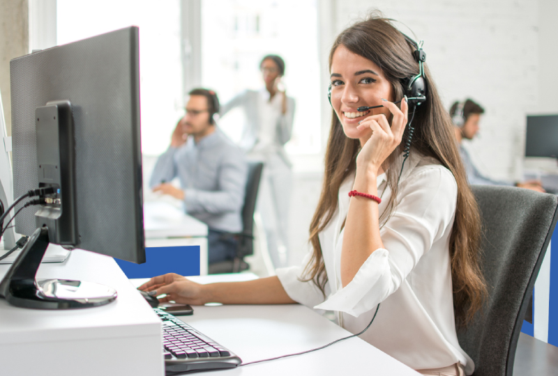 Female IT Technician Wearing Headset, Sitting at Computer