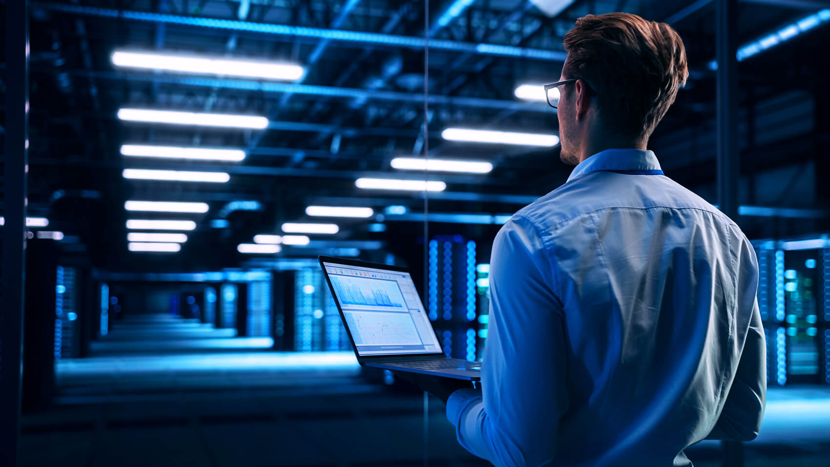 gsd-it-solutions IT professional in a server room holding a laptop